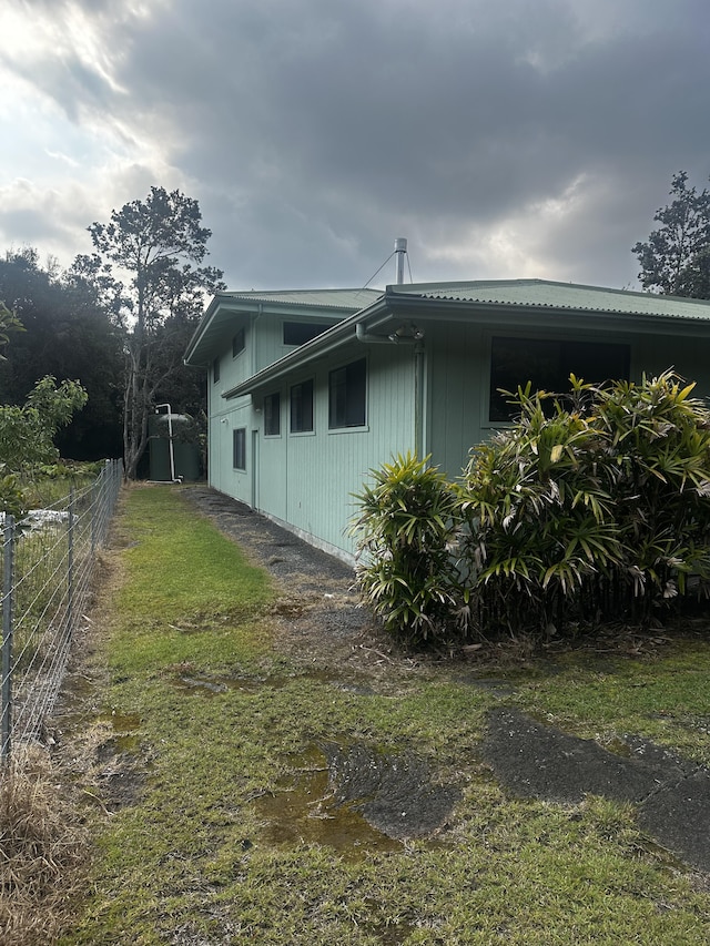 view of property exterior with fence