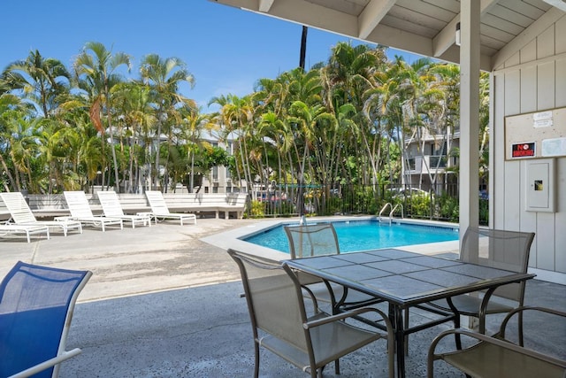 pool featuring a patio and fence