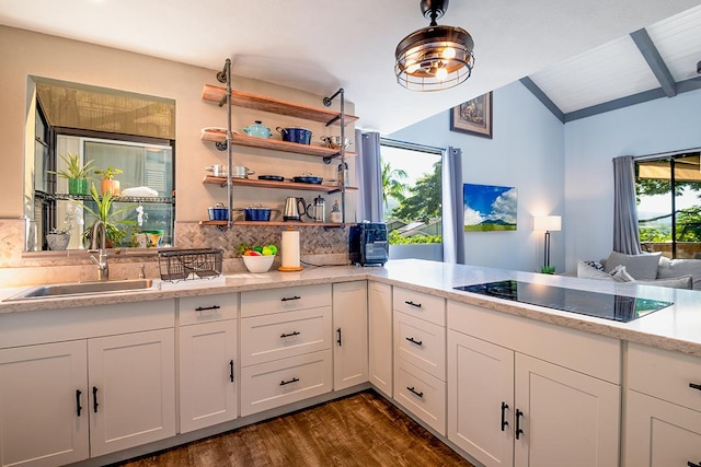 kitchen with backsplash, dark wood-type flooring, white cabinetry, black electric cooktop, and a sink