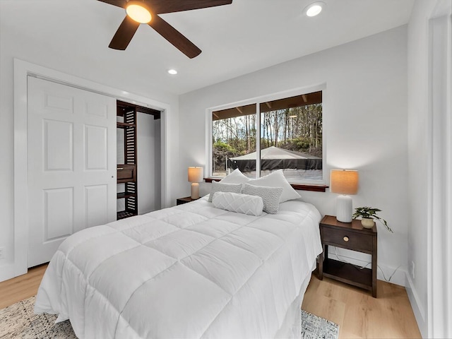 bedroom with wood finished floors, a ceiling fan, and recessed lighting