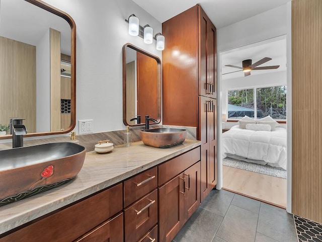 full bath with a ceiling fan, tile patterned flooring, a sink, and double vanity