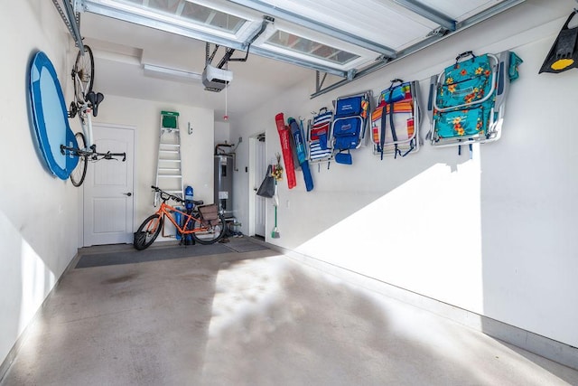 garage with a garage door opener and electric water heater