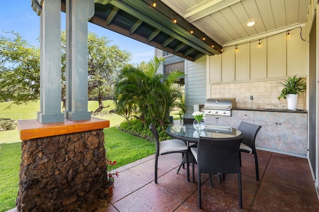 view of patio with outdoor dining space and a grill