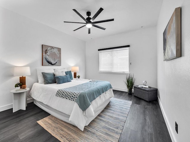 bedroom with a ceiling fan, baseboards, and dark wood-type flooring