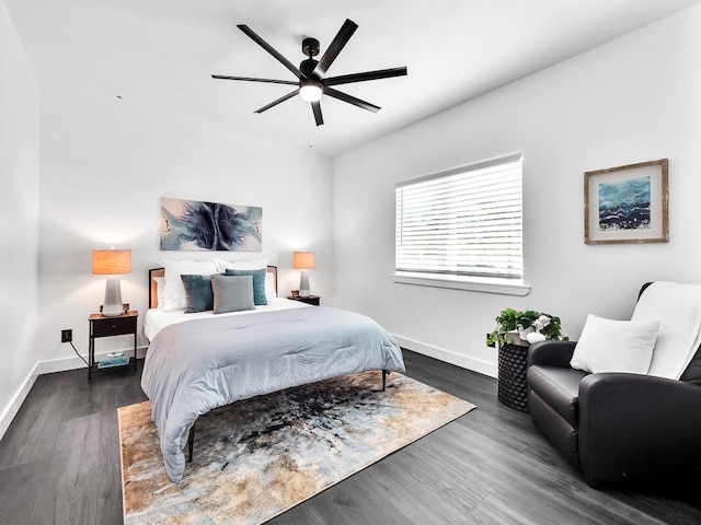 bedroom featuring baseboards, dark wood finished floors, and a ceiling fan