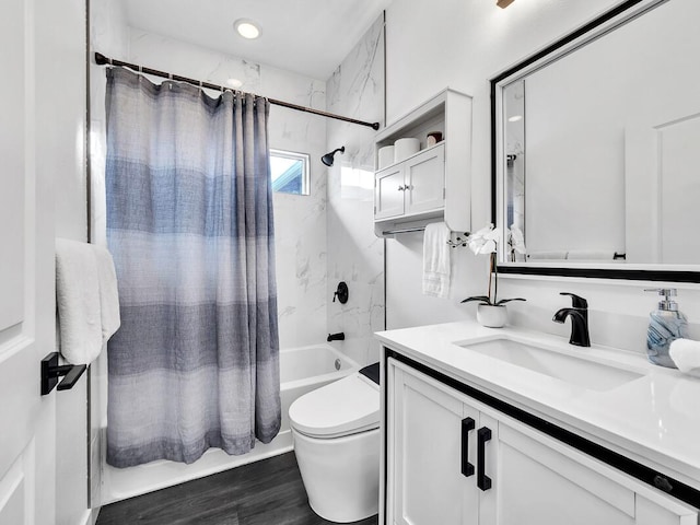 bathroom with toilet, shower / tub combo, wood finished floors, and vanity