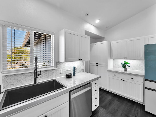 kitchen featuring a sink, vaulted ceiling, stainless steel dishwasher, and light countertops