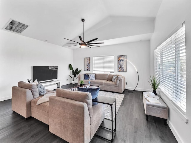 living room with dark wood-type flooring, plenty of natural light, visible vents, and baseboards