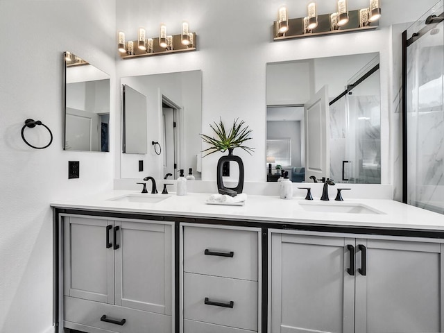 full bath with a stall shower, a sink, and double vanity