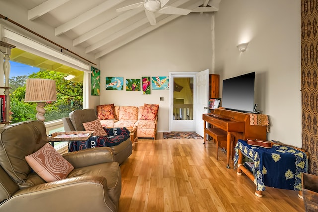living area featuring beamed ceiling, high vaulted ceiling, wood finished floors, and a ceiling fan