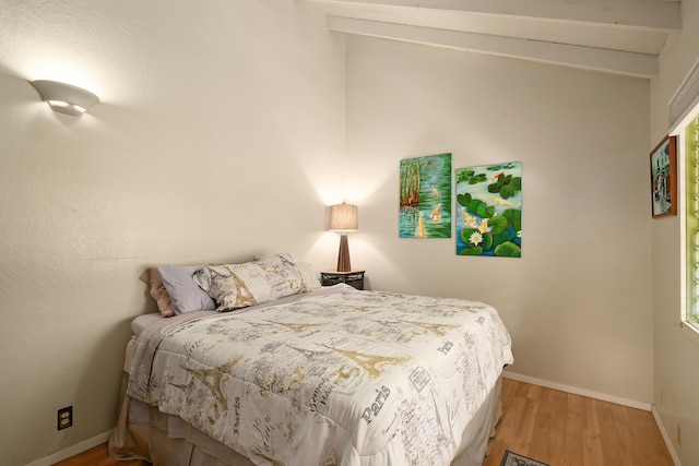 bedroom with baseboards and wood finished floors