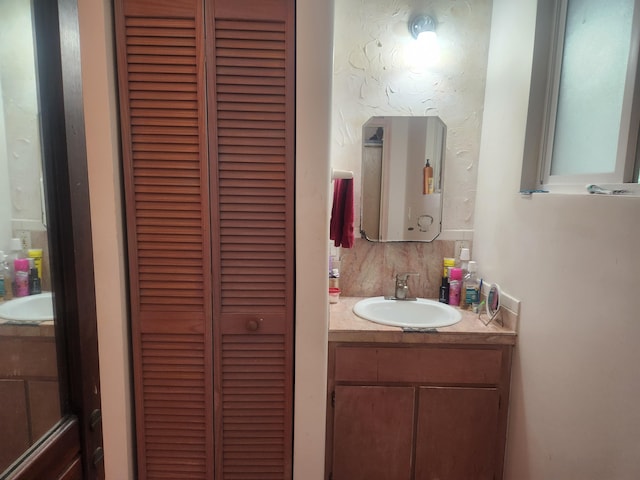 bathroom featuring a closet and vanity