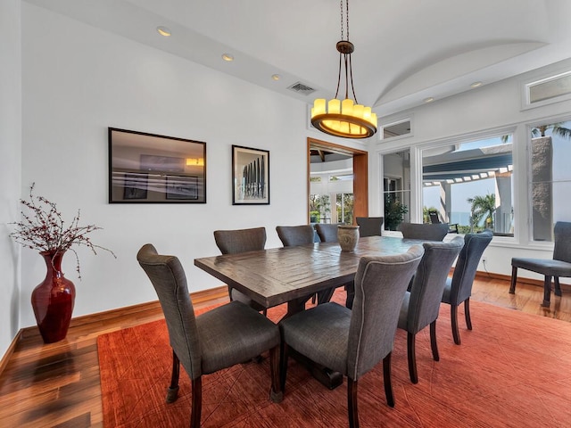 dining space featuring visible vents, a healthy amount of sunlight, baseboards, and wood-type flooring