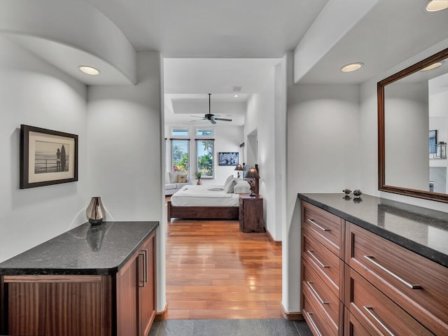 ensuite bathroom with wood finished floors, recessed lighting, connected bathroom, ceiling fan, and vanity