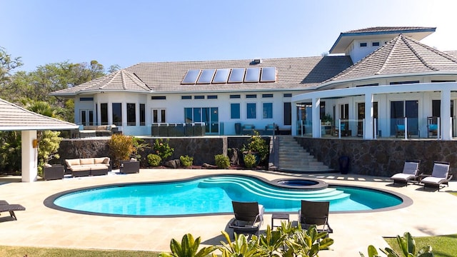 exterior space with a patio area, an outdoor hangout area, stairs, and an in ground hot tub