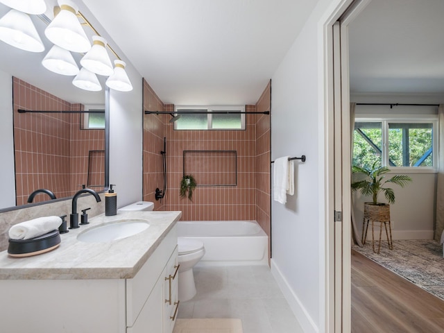 full bathroom featuring a wealth of natural light, bathing tub / shower combination, vanity, and toilet