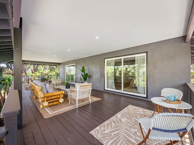 wooden terrace featuring an outdoor living space