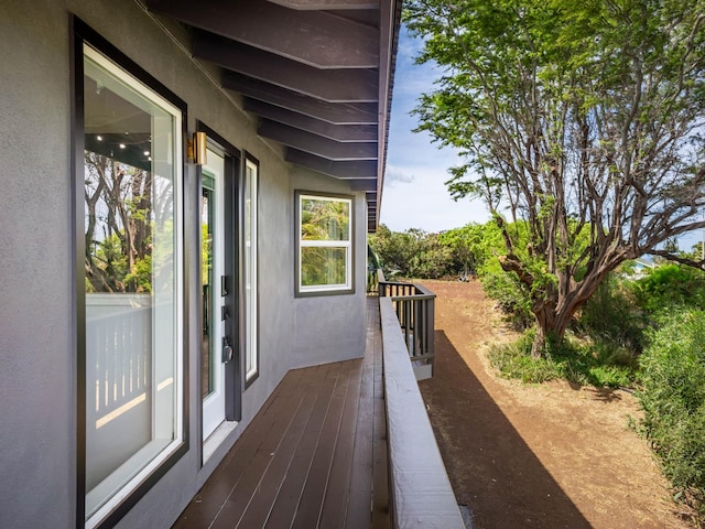 view of property exterior with stucco siding and a balcony