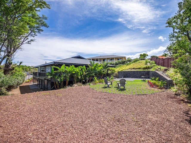view of yard with fence and stairs