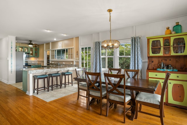 dining space with a notable chandelier and light wood-style flooring