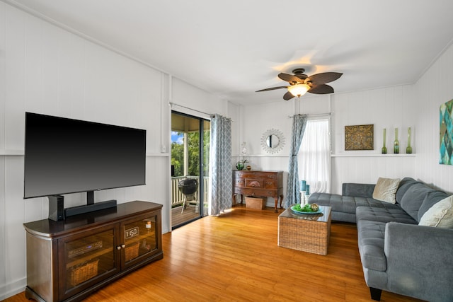 living area with plenty of natural light, light wood-style flooring, and a ceiling fan