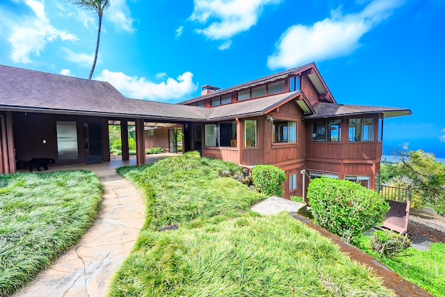 exterior space featuring a shingled roof