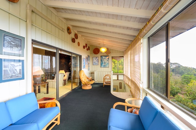 sunroom / solarium with vaulted ceiling with beams