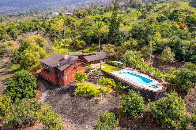 birds eye view of property with a view of trees