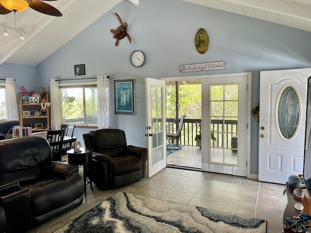 living room with plenty of natural light, beamed ceiling, french doors, and high vaulted ceiling