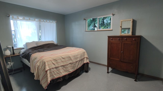 bedroom with multiple windows and baseboards