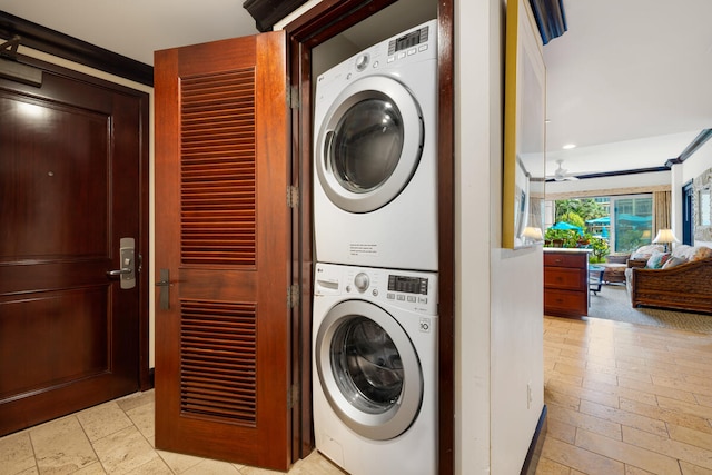 clothes washing area featuring laundry area and stacked washer and dryer