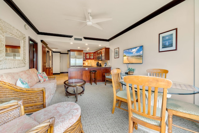 living area with visible vents, ceiling fan, and crown molding