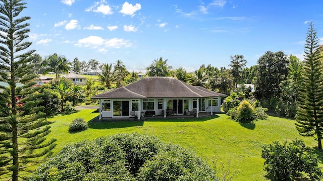 rear view of house with a yard