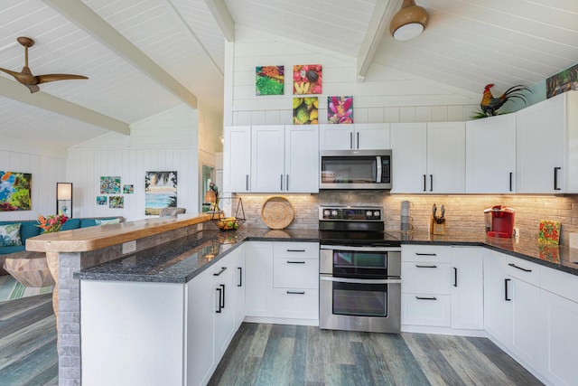 kitchen featuring stainless steel appliances, tasteful backsplash, a peninsula, and vaulted ceiling with beams