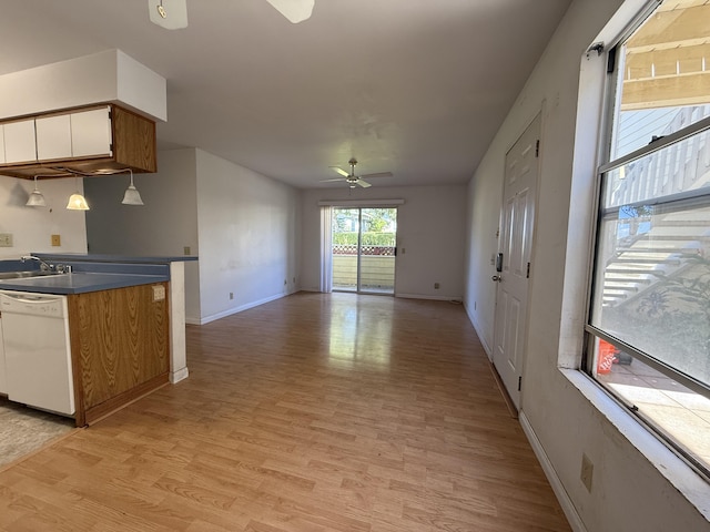 kitchen with dark countertops, dishwasher, light wood-style floors, white cabinetry, and a ceiling fan