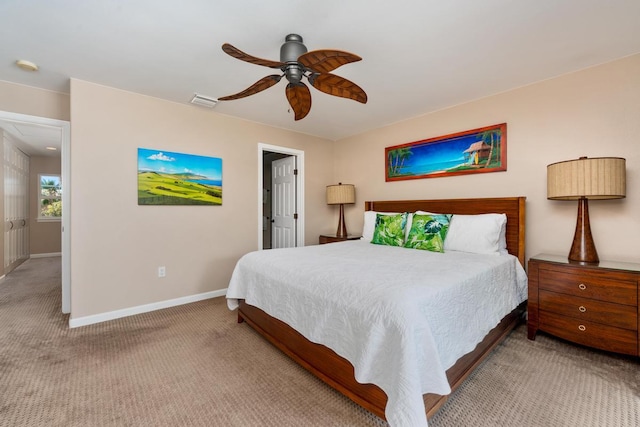 carpeted bedroom with visible vents, baseboards, and a ceiling fan