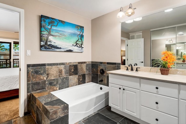 bathroom featuring vanity, a garden tub, and ensuite bathroom