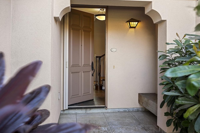 property entrance with stucco siding