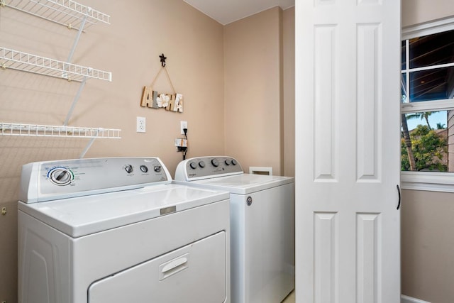 washroom with laundry area and independent washer and dryer