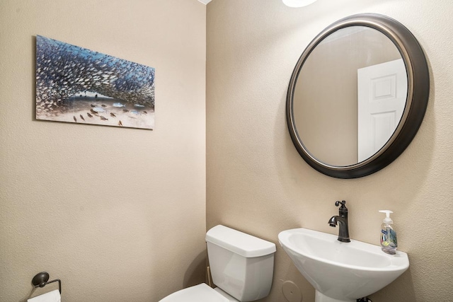 bathroom with toilet and a sink