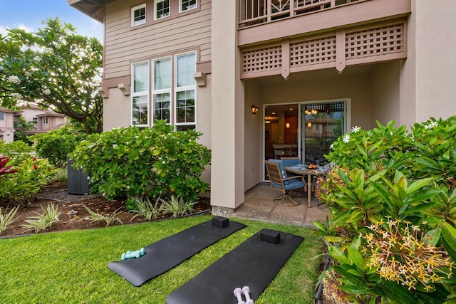 exterior space featuring a patio area and stucco siding