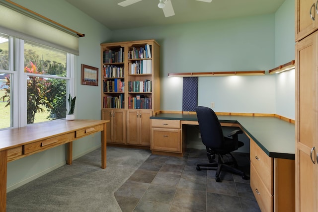 office with ceiling fan and baseboards