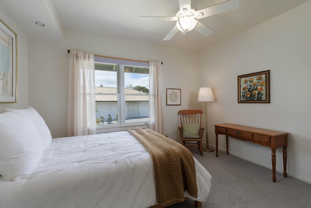 bedroom featuring light carpet, baseboards, and a ceiling fan