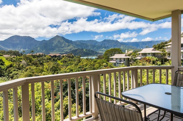 balcony featuring outdoor dining space and a mountain view