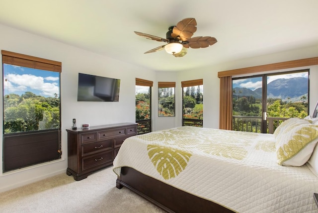 bedroom with light colored carpet, ceiling fan, and access to exterior