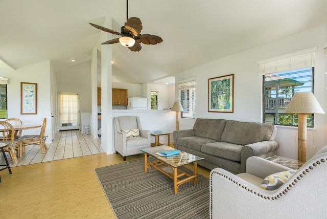 living area featuring lofted ceiling, ceiling fan, and light wood finished floors