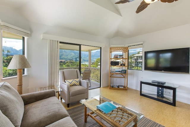 living room with lofted ceiling, wood finished floors, a ceiling fan, and a healthy amount of sunlight