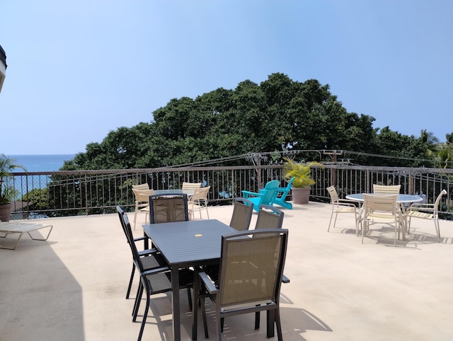 view of patio / terrace with outdoor dining area and a water view