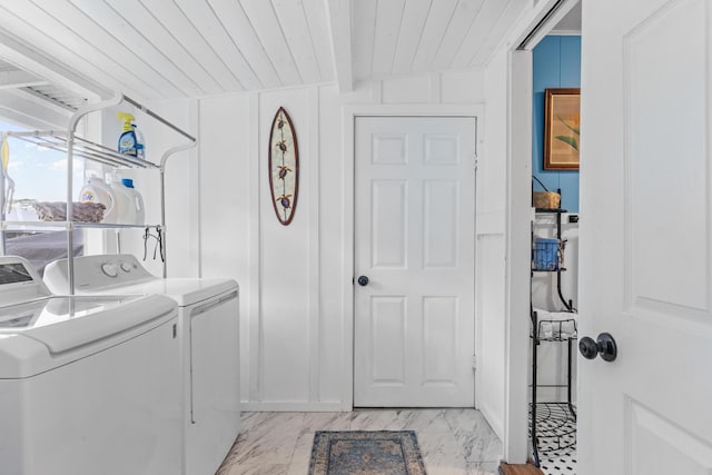 clothes washing area featuring laundry area, wood ceiling, separate washer and dryer, and marble finish floor