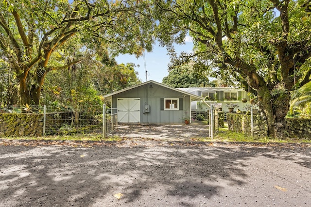 exterior space with board and batten siding, an outdoor structure, and fence